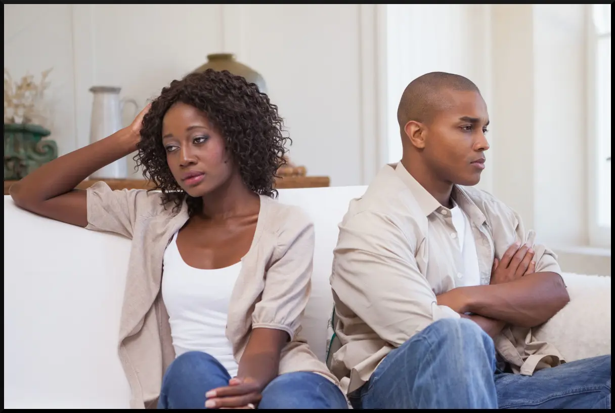 Divorce Lawyer: Unhappy Couple Turned Away from Each Other on Couch